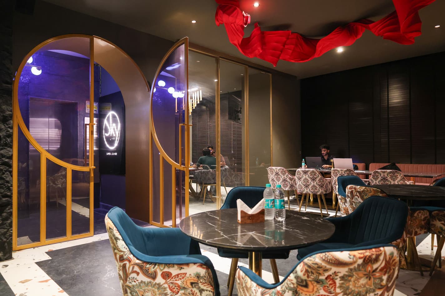 Lounge seating area with velvet chairs.