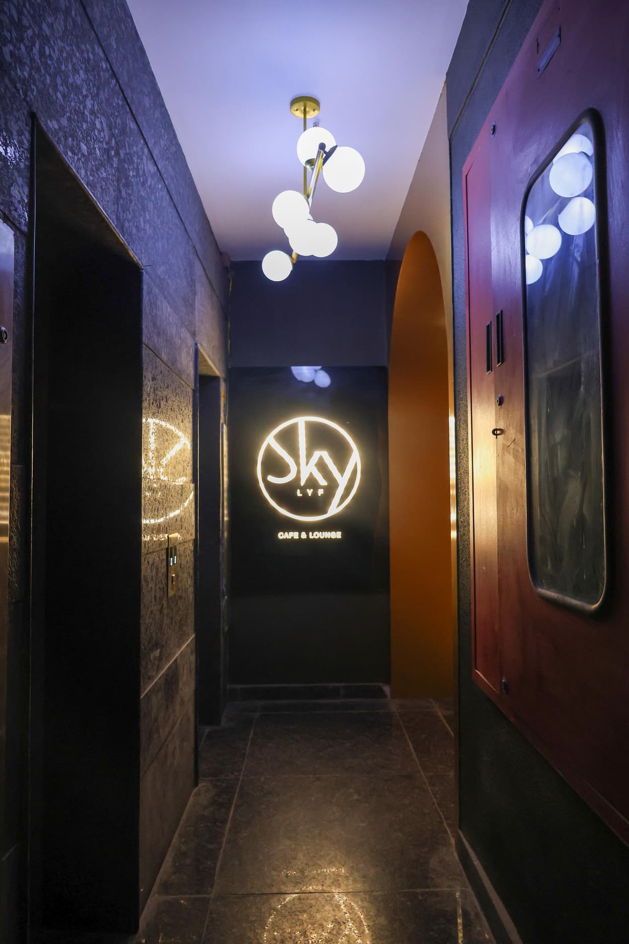 Lounge entrance with a glowing circular sign.