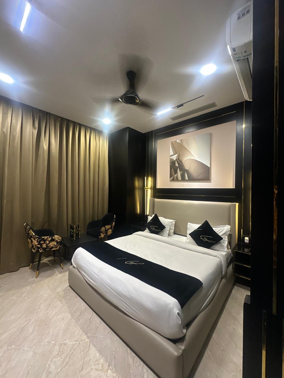 Regal Suite bedroom, dark moody interior with warm spot lighting.