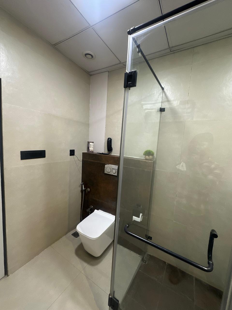 Regal Suite bathroom with black vessel sink and gold fixtures.