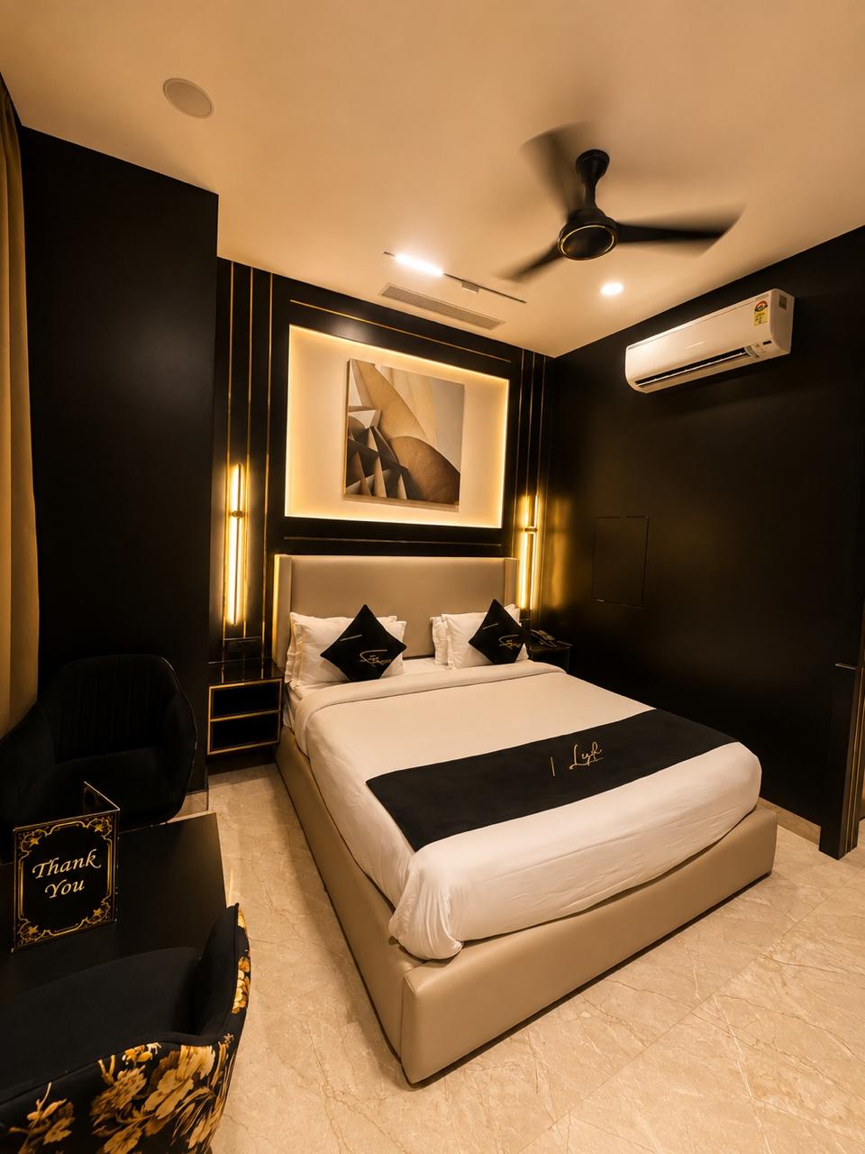 Regal Suite bedroom under warm gold pendant lighting.